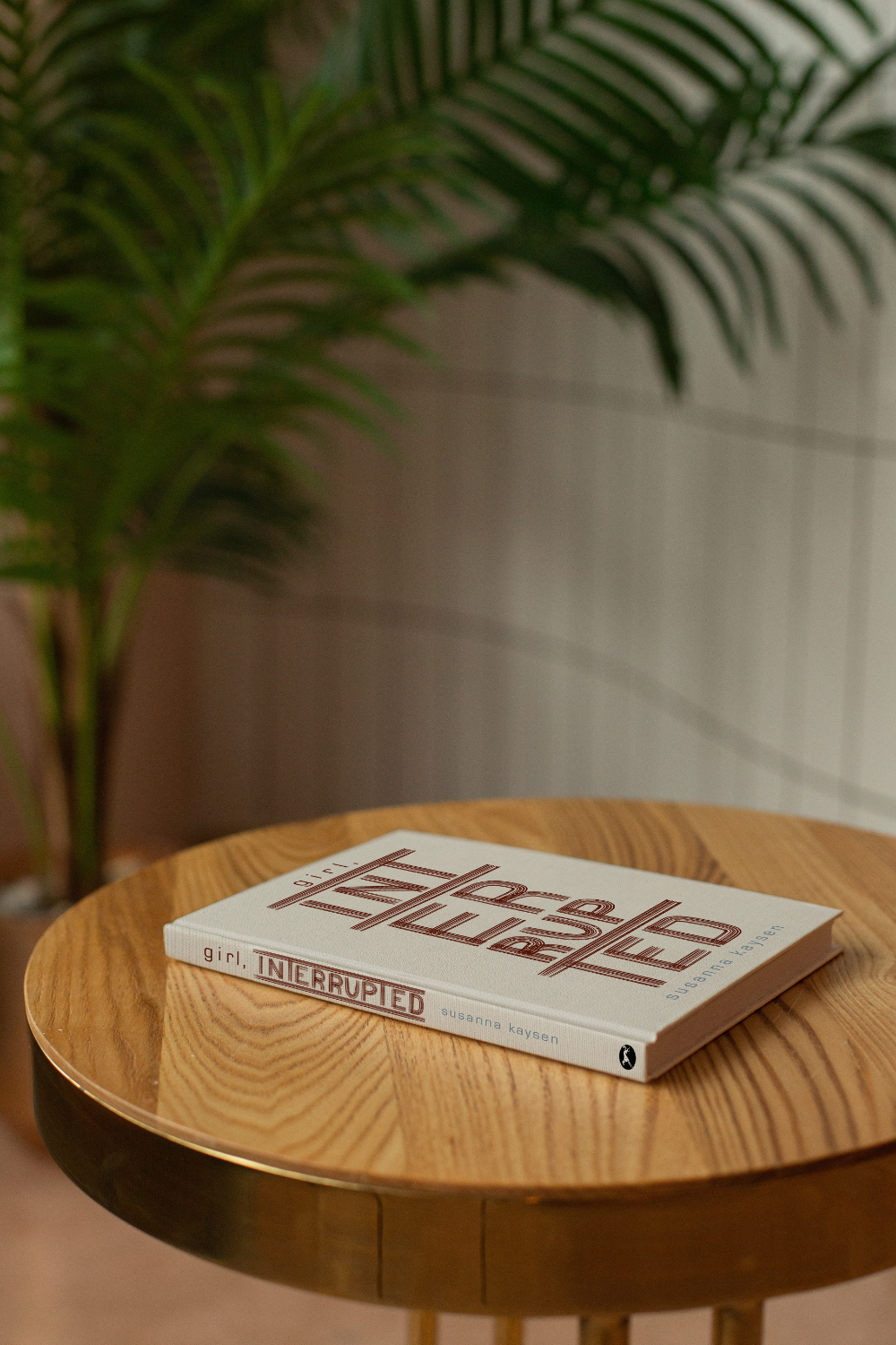 Girl Interrupted book mocked up sitting on a table.